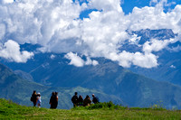 Tour group at Moray gaze at distant Andes